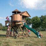 Backyard Discovery Eagles Nest Cedar Wooden Playhouse Playset with 7-Foot Crow's Nest Wave Slide and Rock Climbing Wall - Image 2