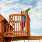 Backyard Discovery Skyfort II Cedar Wood Playset Swing Set with Raised Clubhouse Wave Slide Monkey Bars and Rock Climbing Wall - Image 7